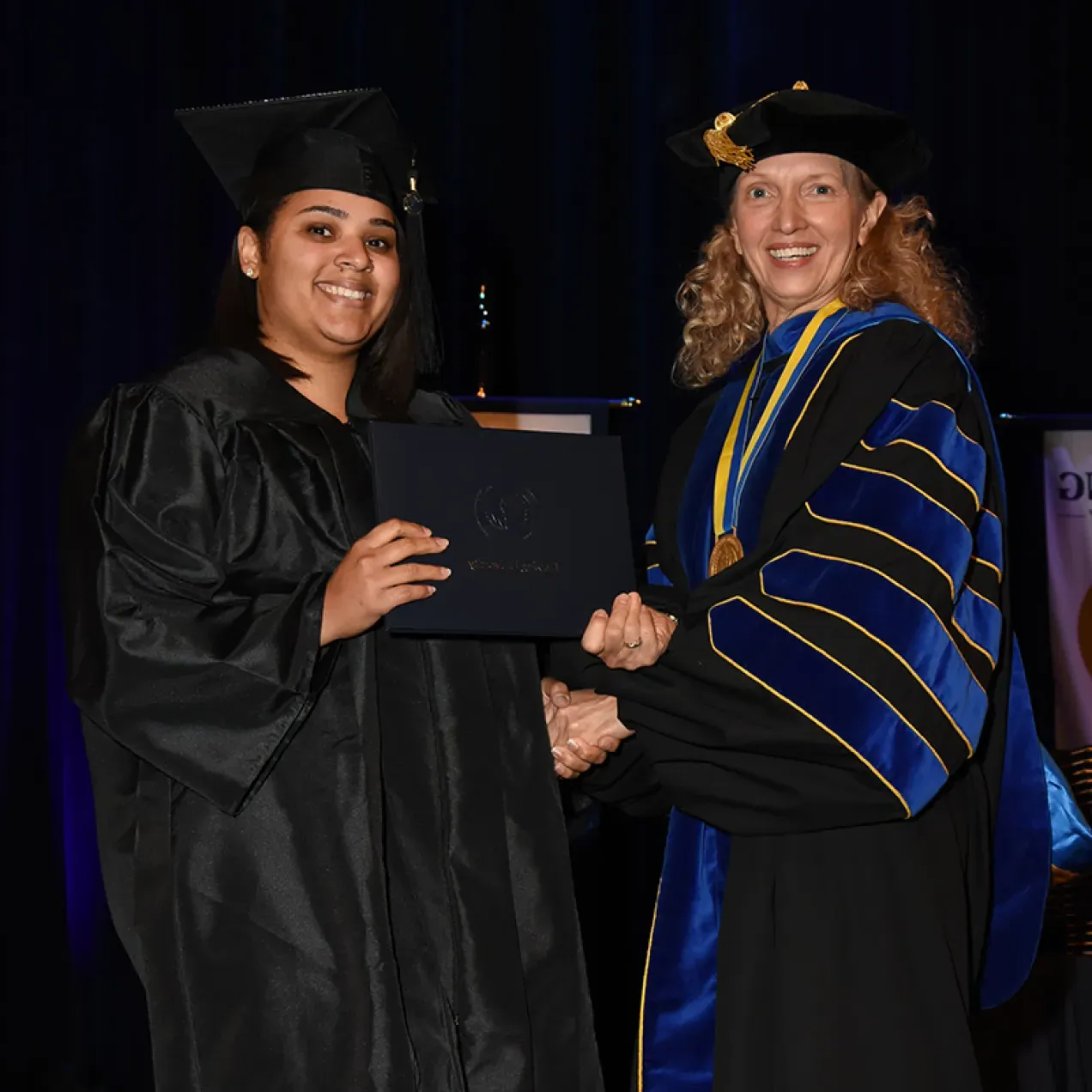 Herzing University graduate receives her diploma